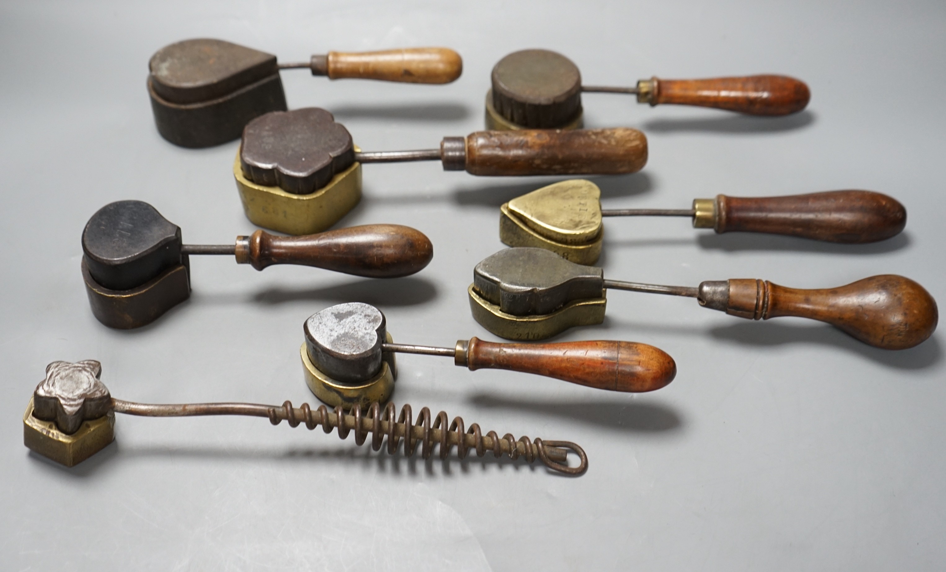 A collection of eight 19th century cast metal moulds for possibly hand embossing silk